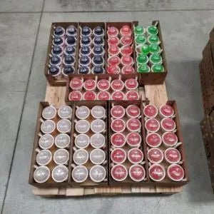 Assorted colored round cups of LOL Bubble Tea in wooden crates on a concrete floor.